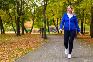 Mid adult woman walking in city park