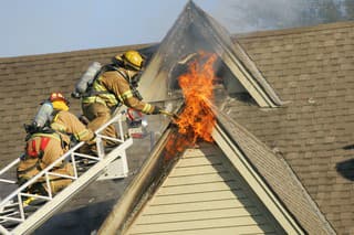 firemen working to put out a house fire