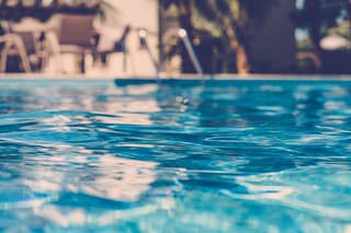 blurred surface view on blue swimming pool