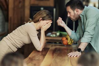 Frustrated parents having an argument in the kitchen.