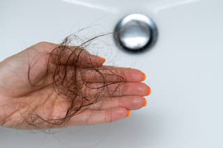 Female hairs in sink. Hair loss concept.