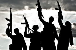 Silhouette of several muslim militants with rifles