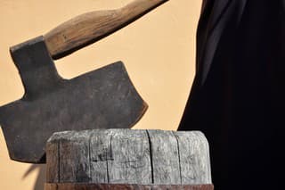 Headsman's axe hewed in old wooden chunk