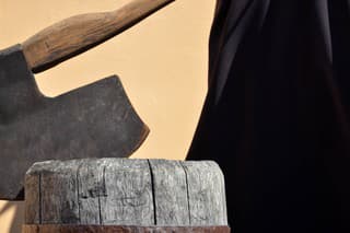 Headsman's axe hewed in old wooden chunk