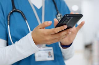 Hands, phone and healthcare with a nurse scrolling in a hospital closeup for research or networking. Medical, communication and information with a medicine professional reading a text in a clinic