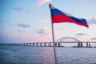 sea sunset, view of the Crimean bridge, the flag of Russia on the yacht, photo from the yacht