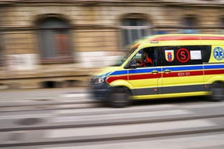 Lodz, Poland - July 08, 2022: A panning shot with an Emergency Service for Resuscitation and Extrication, ambulance speeding through the traffic rushing towards hospital