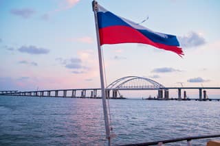 sea sunset, view of the Crimean bridge, the flag of Russia on the yacht, photo from the yacht