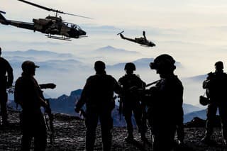 Silhouettes of soldiers during Military Mission at dusk