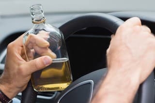 Man drinking alcohol while driving in his car