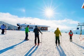 Rohrberg, Austria - February 4, 2019: People Skiers skiing in Zillertal Arena ski resort in Tyrol in Mayrhofen in Austria in winter Alps. Ski in Alpine mountains with white snow and blue sky.