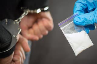 A police officer finds drugs during the search of drug dealers