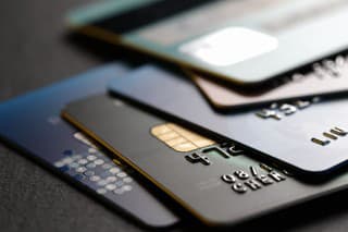 stack of multicolored credit cards on black background