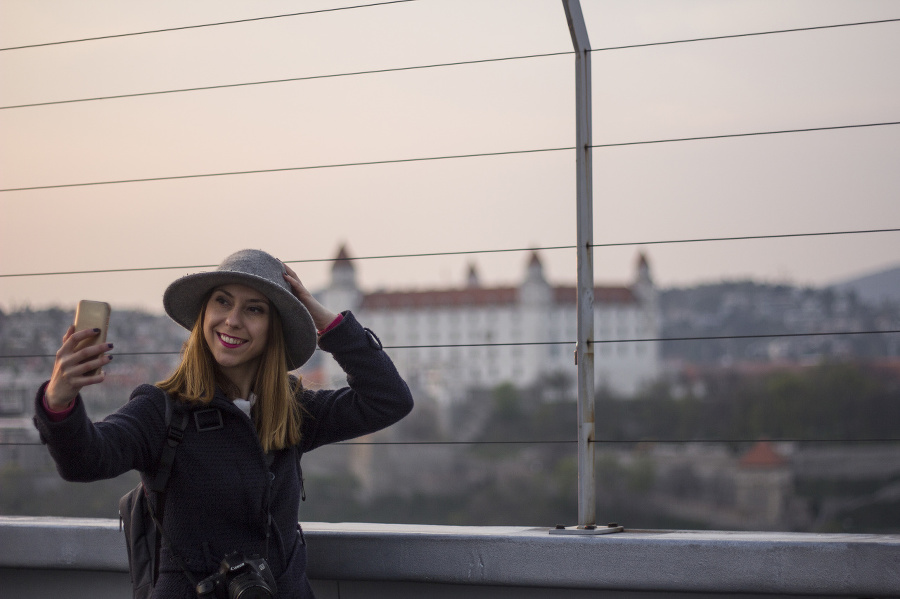 Young female tourist photographing