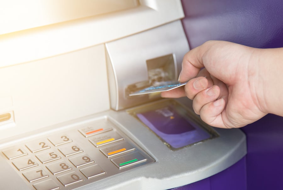 Hand inserting ATM credit