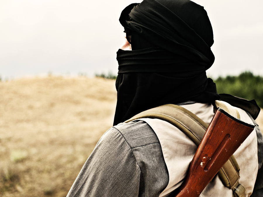 Muslim rebel with automatic rifle and machine-gun belt