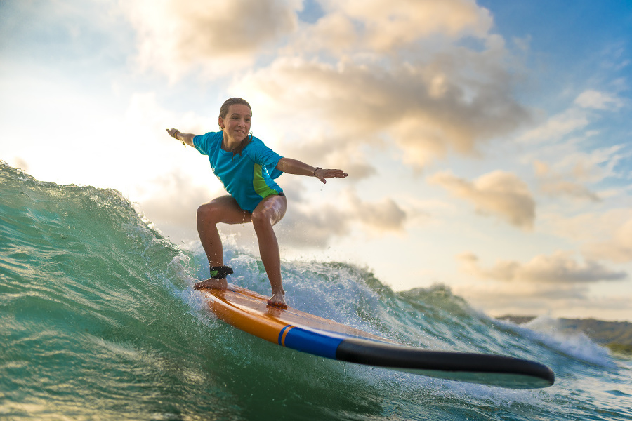 Young girl surfing at