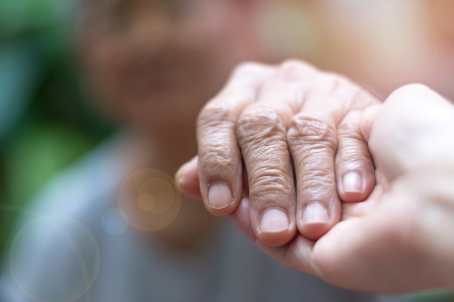 Caregiver, carer hand holding
