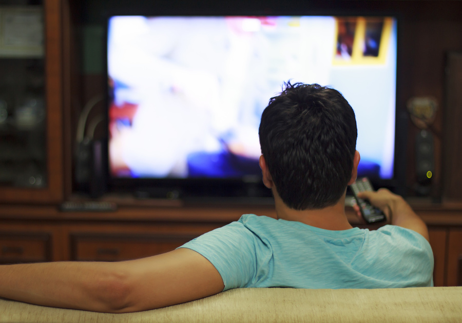Male watching television in