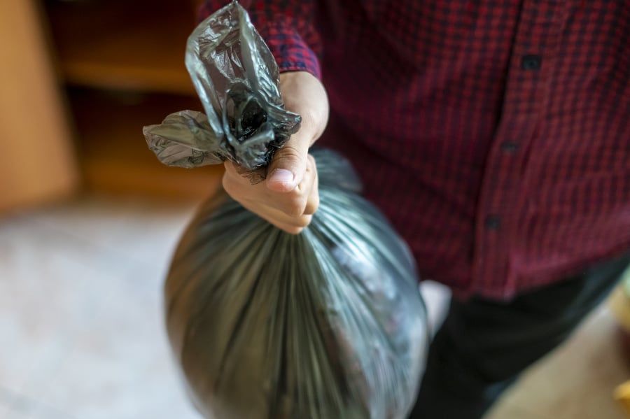 hand holding a trash