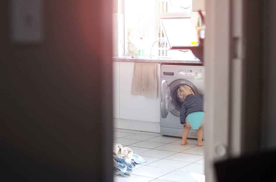 Toddler inspecting a washing