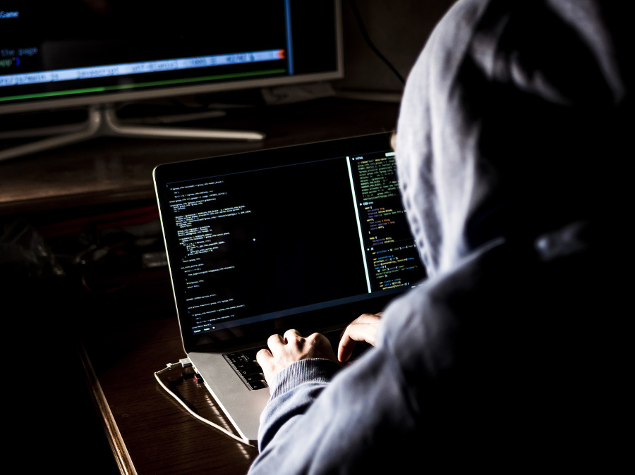 hacker in hoodie typing