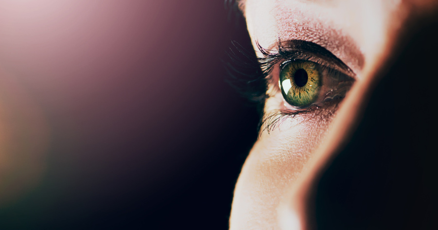 Studio shot of a man opening his eyes against a dark background