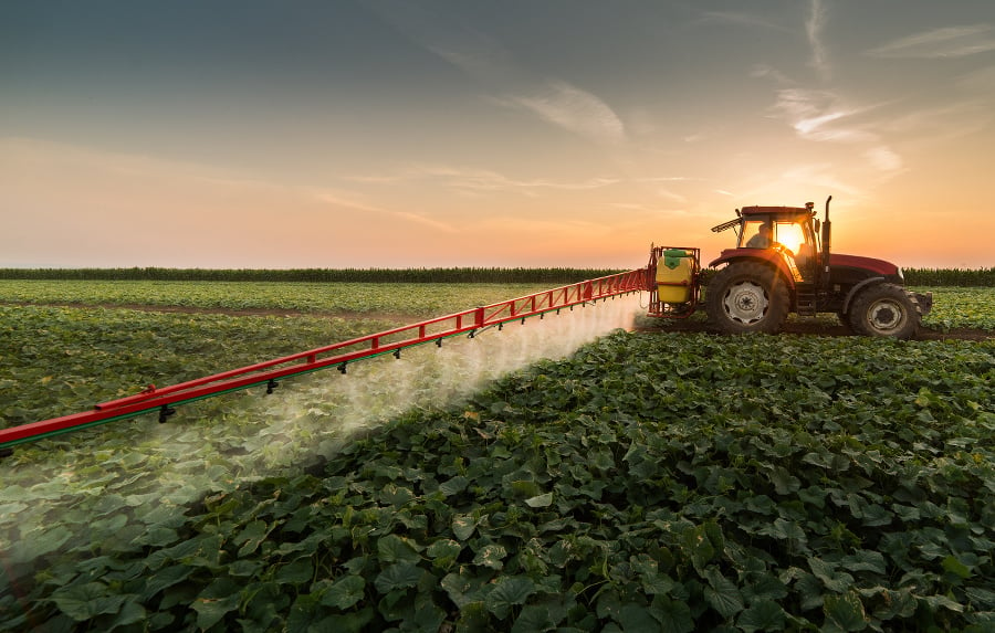Tractor spraying pesticides on