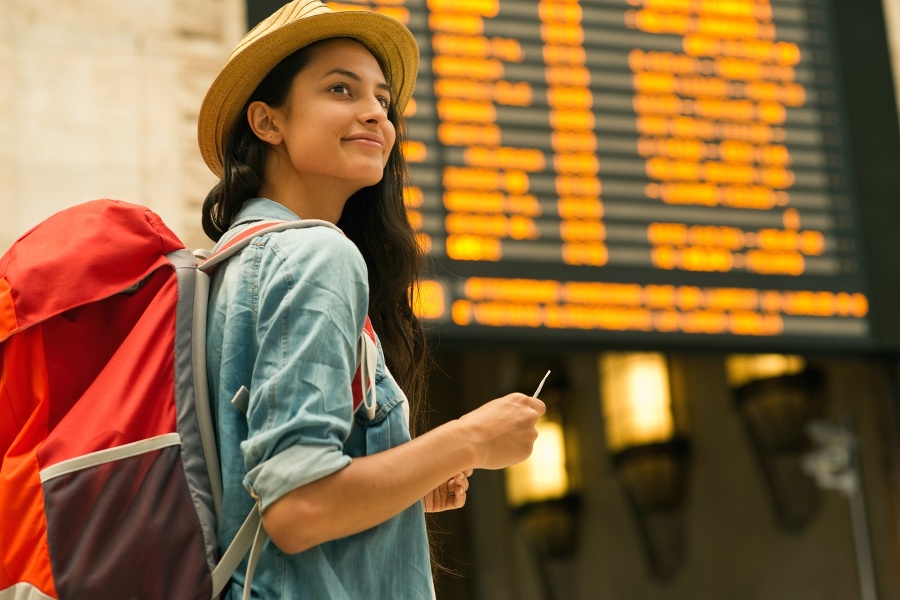 Young woman checking her train in time board