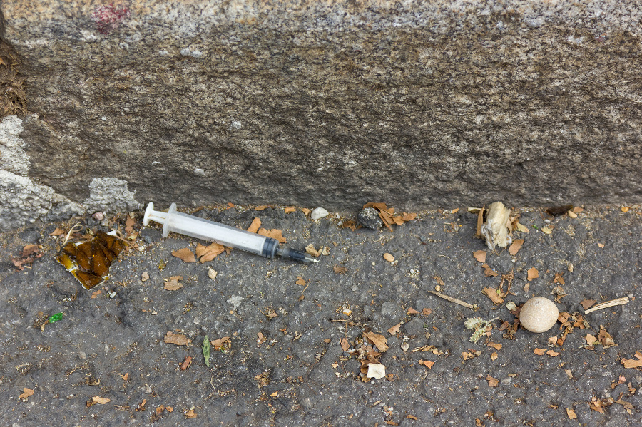 Used syringe lying on
