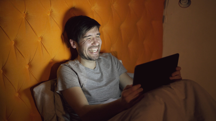 Young laughing man using