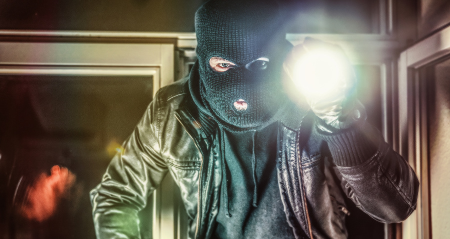 Masked burglar with pistol