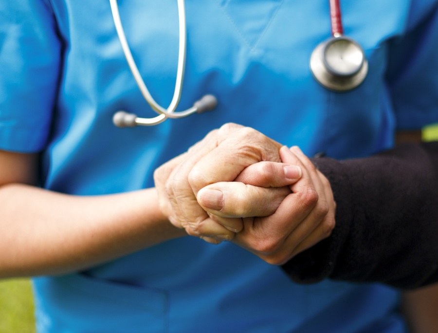 Doctor helping old patient