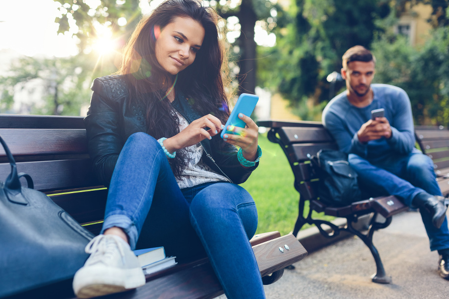 Teenage couple using smartphones