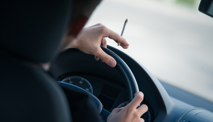 Man driving and smoking