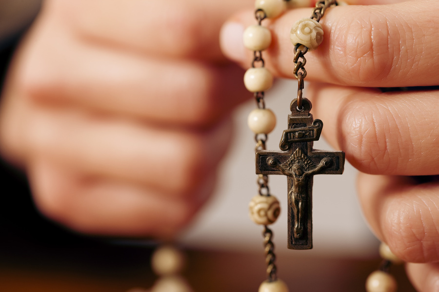 Woman praying with rosary