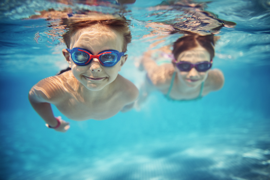 Smiling kids enjoying underwater