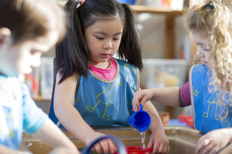 Young children wearing aprons