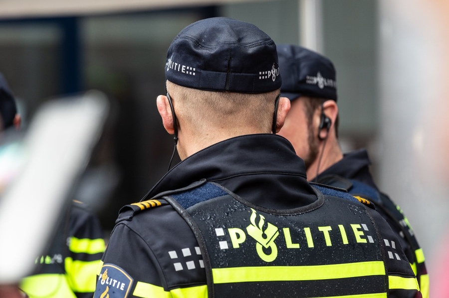 Amersfoort, The Netherlands - April 27th 2019: Dutch policeman in uniform keeps an eye on the environment during Kingsday at Amerfoort, The Netherlands