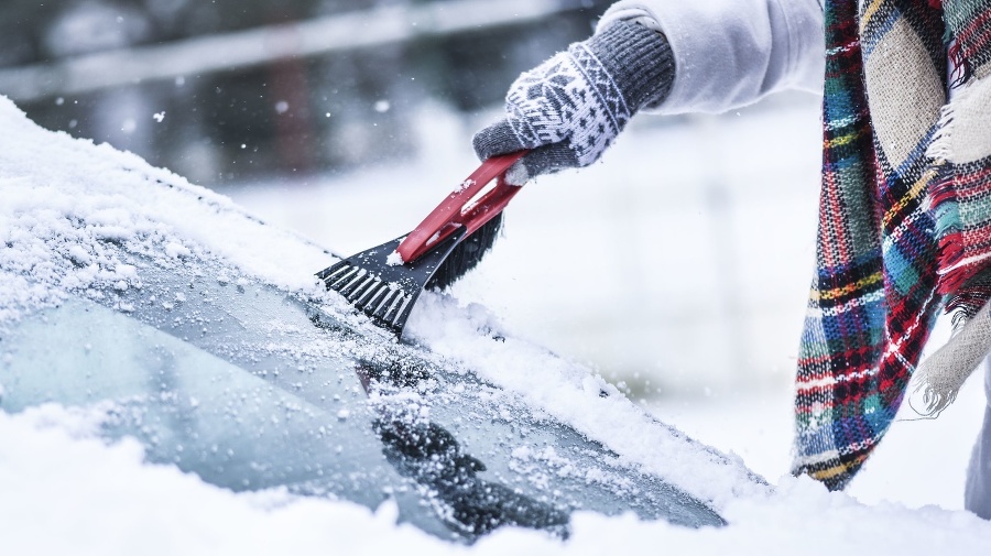 Woman cleaning snow from