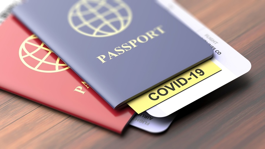 Coronavirus and travel concept. COVID-19 note on a passport. Border control and tourists infected quarantine,
Travelling documents on wooden table, closeup view. 3d illustration