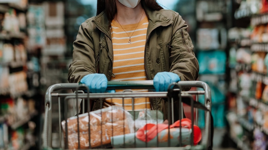 Woman pushing supermarket cart