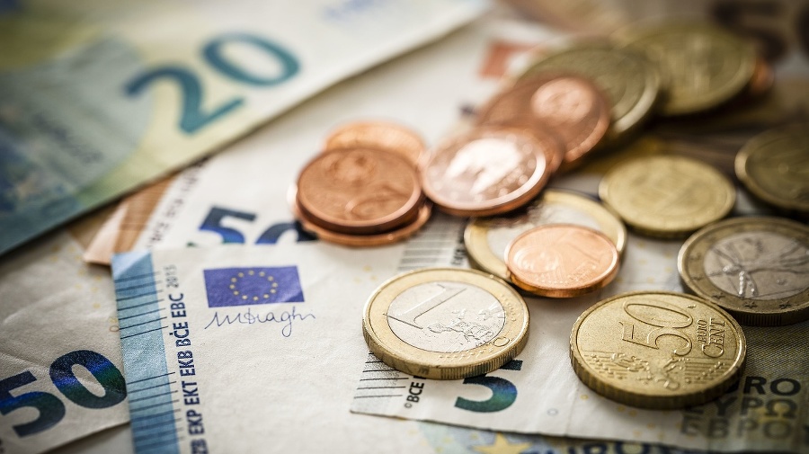 Close up view of European Union banknotes and coins. Selective focus on the one Euro coin. DSRL studio photo taken with Canon EOS 5D Mk II and Canon EF 100mm f/2.8L Macro IS USM.
