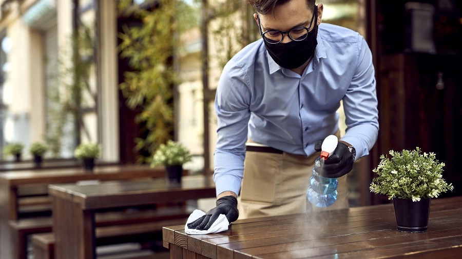 Waiter wearing protective face