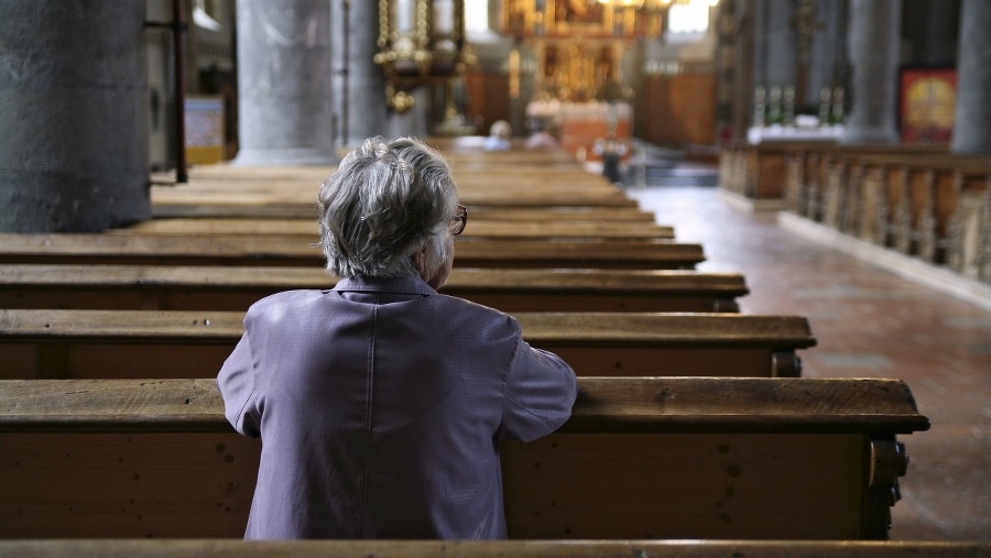 Older woman praying in