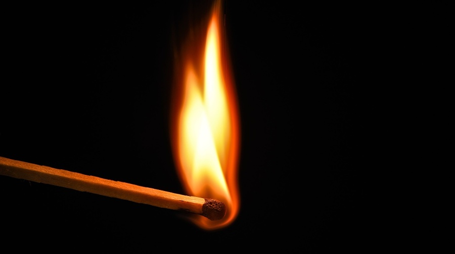 Fire burning on matchstick.