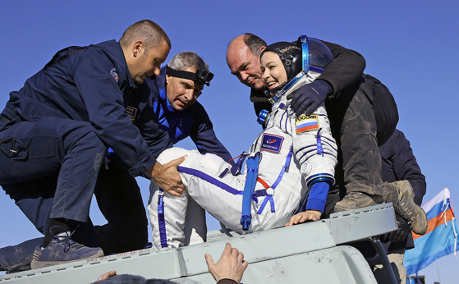 Po návrate Julii Peresild pomáhajú z kapsuly Sojuz. 