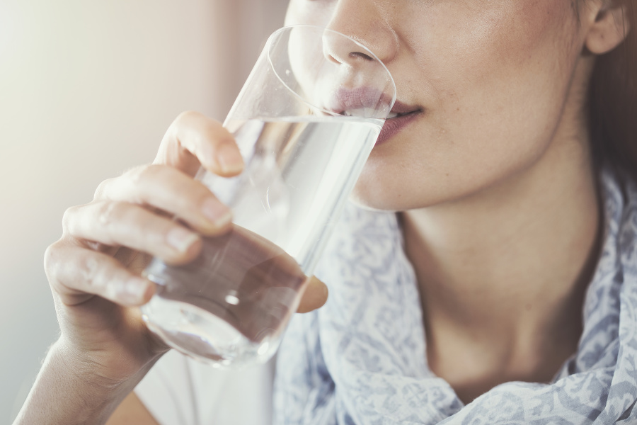 Young woman drinking pure