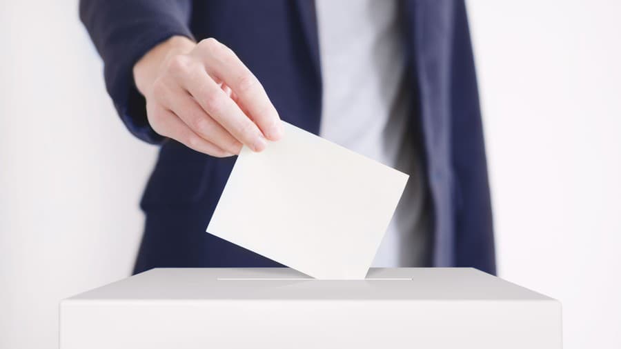 Man putting a ballot