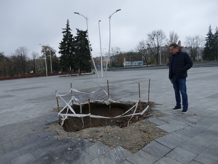 Starosta Kramatorska Oleksandr Gončarenko ukazuje jamu, ktorú vyhĺbila ruská bomba.